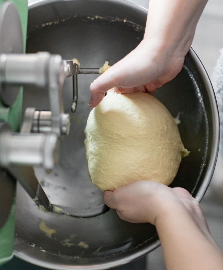 Dough being kneaded in the bowl